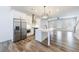 Modern kitchen with stainless steel appliances, white cabinets, and a large island at 6645 Cortland Walk, Alpharetta, GA 30005