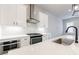Modern kitchen features white cabinets, sleek countertops, and stainless steel appliances at 6645 Cortland Walk, Alpharetta, GA 30005