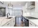 Open kitchen featuring marble countertops, stainless appliances, and a view into the dining area at 6645 Cortland Walk, Alpharetta, GA 30005