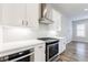 Modern kitchen with white cabinets, stainless steel appliances, and gray subway tile backsplash at 6645 Cortland Walk, Alpharetta, GA 30005