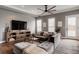 Cozy living room with plush seating, ceiling fan, and natural light from the windows at 6645 Cortland Walk, Alpharetta, GA 30005
