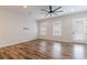 Bright living room with hardwood floors, neutral walls, and a door to the outside at 6645 Cortland Walk, Alpharetta, GA 30005