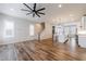 Open-concept living area featuring hardwood floors, staircase, kitchen and ample natural light at 6645 Cortland Walk, Alpharetta, GA 30005