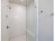 Modern shower stall with white subway tile surround, glass door, and bench at 6645 Cortland Walk, Alpharetta, GA 30005