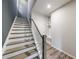 Staircase with neutral walls and hardwood floors at 6645 Cortland Walk, Alpharetta, GA 30005