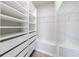 Spacious walk-in closet featuring custom shelves and drawers to maximize organization and efficient storage at 6645 Cortland Walk, Alpharetta, GA 30005