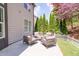Relaxing patio seating area with beautiful landscaping and a white picket fence at 2720 Garonne Way, Cumming, GA 30041