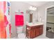 Bathroom vanity with a large mirror, white countertops, and dark cabinets at 2720 Garonne Way, Cumming, GA 30041