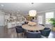 Open-concept kitchen and dining area with a large island, breakfast bar, and direct view into the living room at 2720 Garonne Way, Cumming, GA 30041
