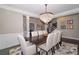 Bright dining room with a modern chandelier, hardwood floors, and a view of the staircase at 2720 Garonne Way, Cumming, GA 30041