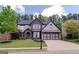 Beautiful two-story home featuring a landscaped yard and an attached two-car garage at 2720 Garonne Way, Cumming, GA 30041