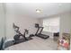 Workout room with a bike, treadmill, weights, and mirrored wall at 2720 Garonne Way, Cumming, GA 30041