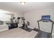 Brightly lit gym with mirrored wall, Peloton bike, and treadmill at 2720 Garonne Way, Cumming, GA 30041