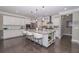Gourmet kitchen features stainless steel appliances, a large island with seating, and ample counter space for cooking at 2720 Garonne Way, Cumming, GA 30041