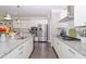 Bright kitchen with granite countertops, stainless steel appliances, and dark wood floors for a modern feel at 2720 Garonne Way, Cumming, GA 30041
