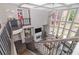 Open-concept living room features large windows, a cozy fireplace, and a view of the upstairs landing with black wrought iron railing at 2720 Garonne Way, Cumming, GA 30041