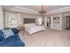 Large main bedroom offers a comfortable seating area, ample closet space, and soft natural light from the windows at 2720 Garonne Way, Cumming, GA 30041
