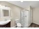 Bathroom featuring modern vanity, toilet, and walk-in shower with glass door at 2880 Field Spring Dr, Lithonia, GA 30058