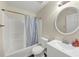 Cozy bathroom featuring tub with shower, toilet, and sink with mirror at 2880 Field Spring Dr, Lithonia, GA 30058