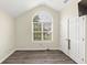 Neutral bedroom featuring arched window, wood floors, and double closet at 2880 Field Spring Dr, Lithonia, GA 30058