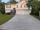 Charming split-level home features a two-car garage, dark shutters, and inviting front yard at 2880 Field Spring Dr, Lithonia, GA 30058