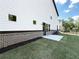 Well-manicured backyard features fresh grass, brick detail and a concrete patio at 5700 Urban Village Way # 1, Tucker, GA 30084