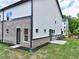 Newly constructed home featuring a brick facade and manicured lawn at 5700 Urban Village Way # 1, Tucker, GA 30084