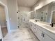 Modern bathroom featuring double vanity, glass shower, and stylish marble flooring at 5700 Urban Village Way # 1, Tucker, GA 30084