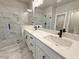 Elegant bathroom showcasing dual sinks and a glass-enclosed shower with marble tile at 5700 Urban Village Way # 1, Tucker, GA 30084