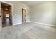 Cozy bedroom boasting neutral walls and carpeting plus view to hallway at 5700 Urban Village Way # 1, Tucker, GA 30084