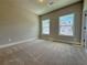 Neutral bedroom featuring plush carpeting and natural light streaming through the windows at 5700 Urban Village Way # 1, Tucker, GA 30084