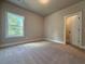 Carpeted bedroom with natural light and a closet at 5700 Urban Village Way # 1, Tucker, GA 30084