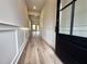 Inviting foyer boasts fresh paint, decorative wainscoting, and stunning wood-look flooring at 5700 Urban Village Way # 1, Tucker, GA 30084