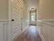 Entryway featuring light-colored walls, lovely wainscoting, and stylish wood-look floors at 5700 Urban Village Way # 1, Tucker, GA 30084