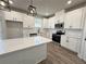 Well-equipped kitchen featuring quartz countertops, stainless steel appliances, and designer pendant lights at 5700 Urban Village Way # 1, Tucker, GA 30084