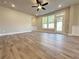 Bright living room featuring modern ceiling fan, recessed lighting, and beautiful luxury vinyl plank flooring at 5700 Urban Village Way # 1, Tucker, GA 30084