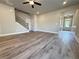 Open-concept living area with beautiful wood-look flooring, recessed lighting, and stairs to the upper level at 5700 Urban Village Way # 1, Tucker, GA 30084