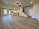 Open living space with modern kitchen, central island, stainless appliances, and staircase at 5700 Urban Village Way # 1, Tucker, GA 30084