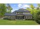 Expansive backyard showcases a charming home, covered porch, and lush green lawn at 885 Old Peachtree Ne Rd, Lawrenceville, GA 30043