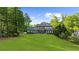 Expansive backyard featuring lush lawn, mature trees and a well-maintained two-story home at 885 Old Peachtree Ne Rd, Lawrenceville, GA 30043