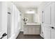 Bathroom with a white vanity, dark wood floors, and a shower-tub combo at 885 Old Peachtree Ne Rd, Lawrenceville, GA 30043