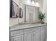 Elegant bathroom with a granite countertop, large mirror, modern fixtures, and decorative plant at 885 Old Peachtree Ne Rd, Lawrenceville, GA 30043