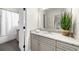 Bathroom featuring gray cabinets, granite countertops, and tile flooring at 885 Old Peachtree Ne Rd, Lawrenceville, GA 30043