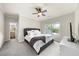 Bedroom with neutral walls, carpet, tv, fan and views to ensuite bath at 885 Old Peachtree Ne Rd, Lawrenceville, GA 30043