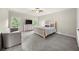 Cozy bedroom featuring a queen bed, dresser, and large windows with natural light at 885 Old Peachtree Ne Rd, Lawrenceville, GA 30043