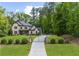Beautiful two-story home with brick and shingle exterior, gated entrance, and mature trees at 885 Old Peachtree Ne Rd, Lawrenceville, GA 30043