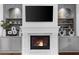 Close up of the cozy fireplace featuring custom built-ins that offer display and storage on either side at 885 Old Peachtree Ne Rd, Lawrenceville, GA 30043
