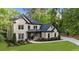 Stunning brick home featuring manicured landscaping, a basketball court, and a charming covered entryway at 885 Old Peachtree Ne Rd, Lawrenceville, GA 30043