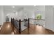 Upstairs landing with hardwood floors, decorative lighting, and view of the foyer at 885 Old Peachtree Ne Rd, Lawrenceville, GA 30043