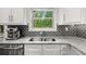 Granite countertops with stainless steel appliances and fixtures give this kitchen a luxurious and modern feel at 885 Old Peachtree Ne Rd, Lawrenceville, GA 30043